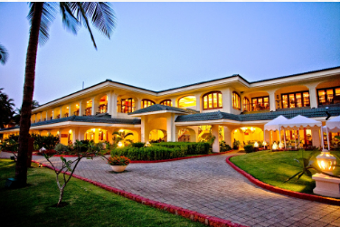 A large house with a lawn and trees

Description automatically generated