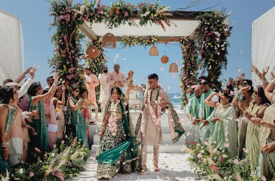 A group of people under a wedding arch

Description automatically generated