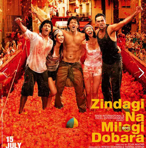 A group of people standing in a red room with a crowd of people

Description automatically generated