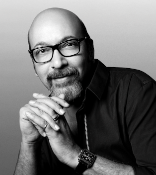 A person with glasses and a beard
Description automatically generated