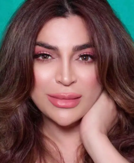 A person with long brown hair and pink makeup
Description automatically generated